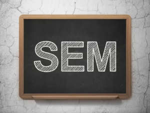 image of a chalkboard where someone has written in SEM in order to discuss search engine marketing services. 