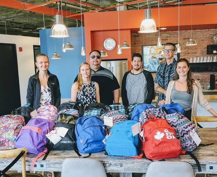 Our team at VonClaro staff with backpacks for charity
