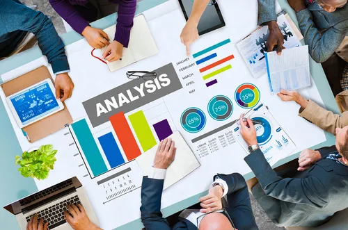 Mock up picture of a group of individuals in a Waterloo Ontario marketing agency discussing data analysis and how VonClaro Inc can help. 