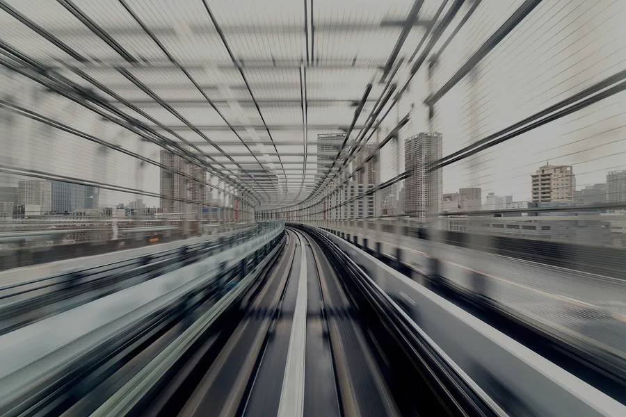 Train tracks over a city receding into the distance