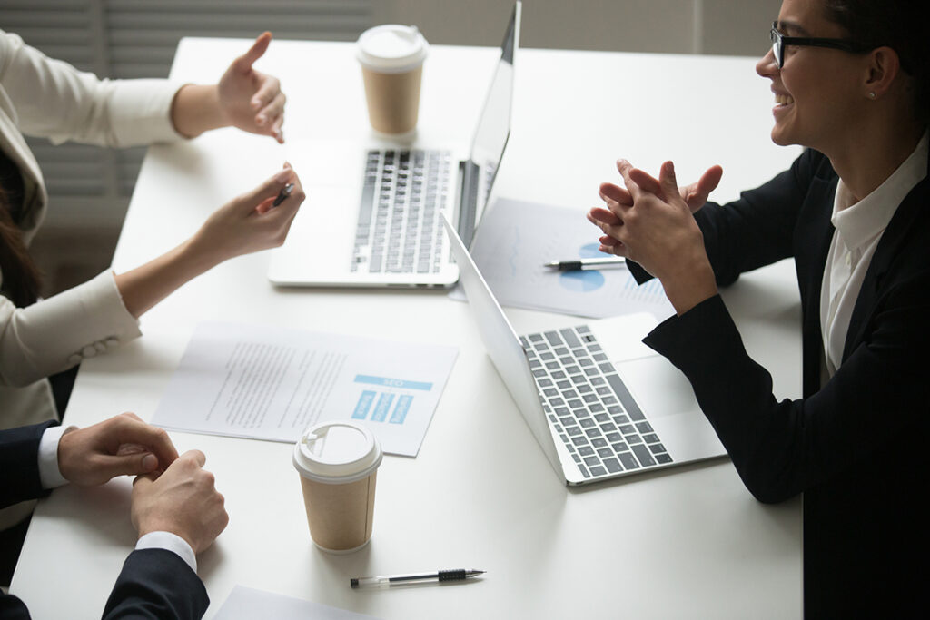 Two individuals sitting at a table Discussing advanced marketing solutions during a digital marketing training seminar