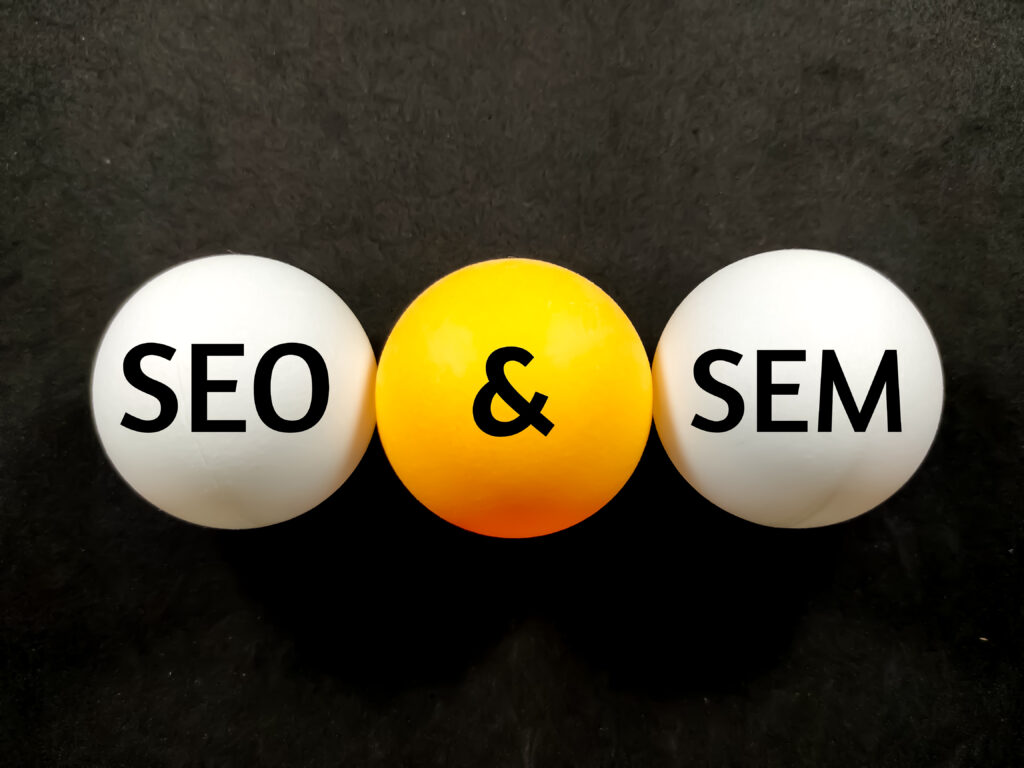 Business concept.Text SEO AND SEM writing on ping pong ball on a black background. seo vs sem.