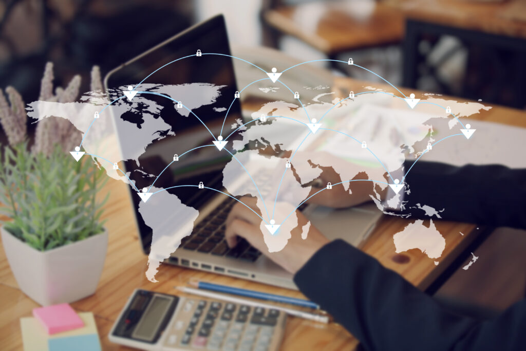 Affordable local SEO services are showcased in this digital composite image featuring a hand using a laptop, representing the optimization of online presence for an international geographical market.

