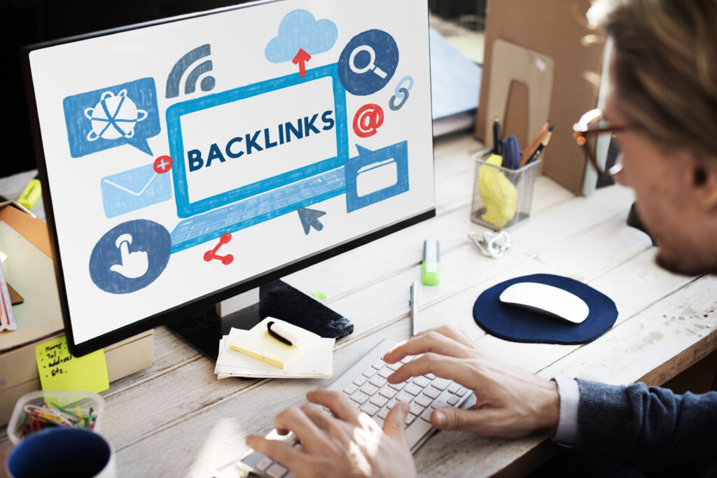 Computer screen with a colorful backlink network illustration, symbolizing the process of conducting a backlink audit.