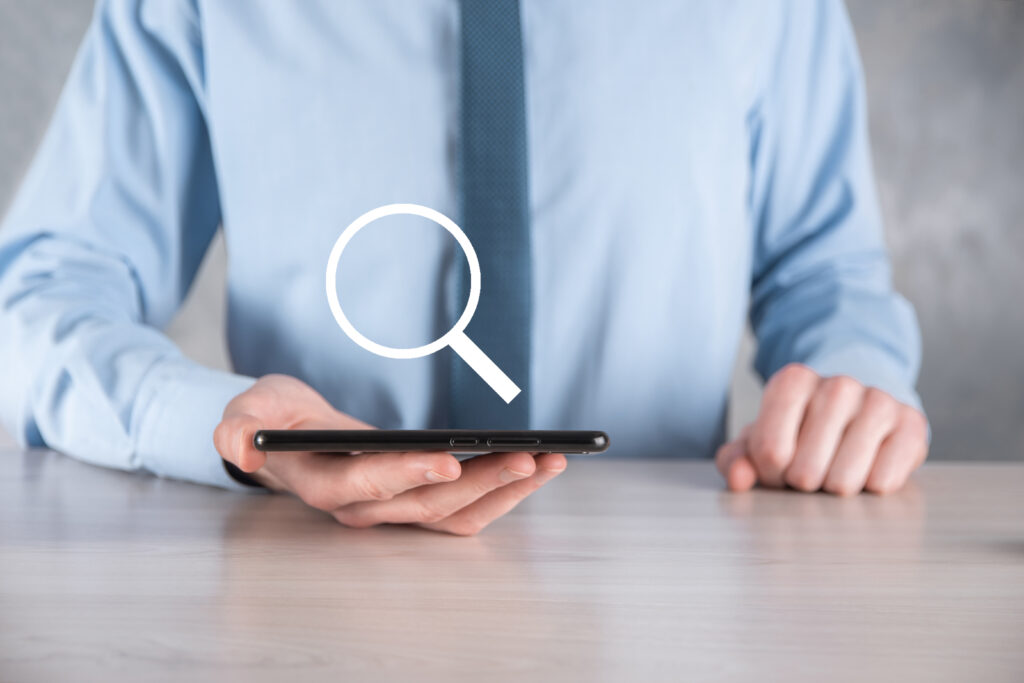 Businessman, man hold in hand magnifying glass icon Mastering how to omit a word from Google search.