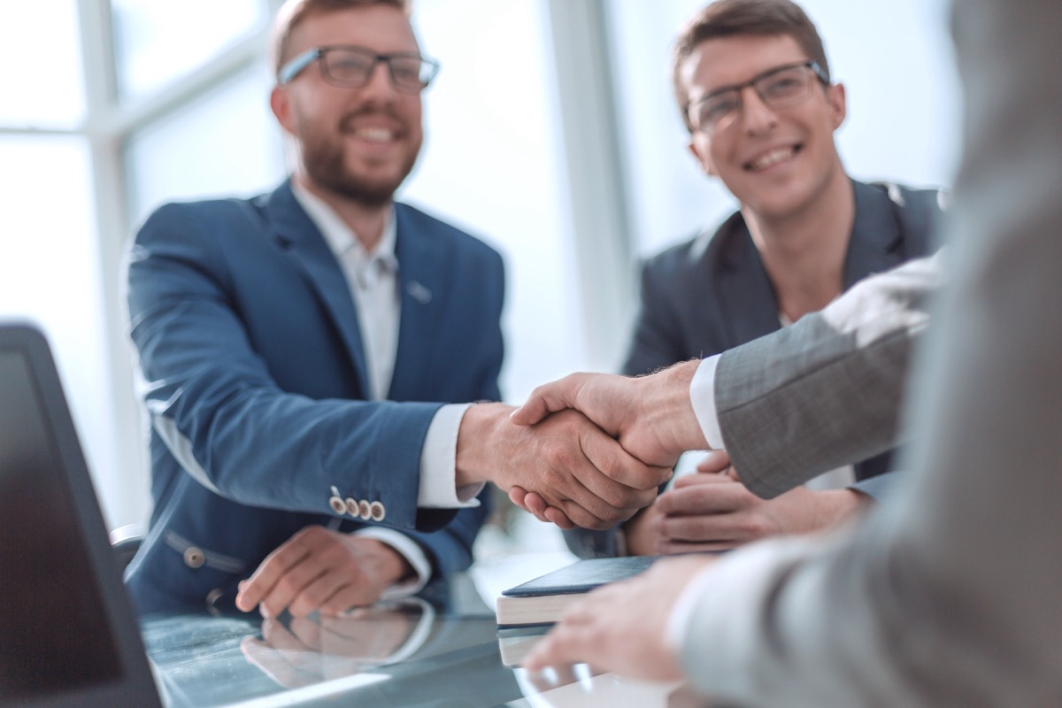 image of a couple of happy clients shaking hands with a businessman. VonClaro offers digital marketing victoria, BC clients the opportunity for face to face meetings.