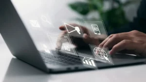 Person using a laptop with digital marketing icons overlayed, symbolizing the tracking of key performance indicators (KPIs) to optimize online strategies and measure campaign effectiveness.