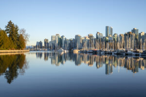 A stunning view of Vancouver’s skyline, with a marina full of boats reflecting on the calm water, representing a global SEO hub in a city known for its blend of nature and urban sophistication.