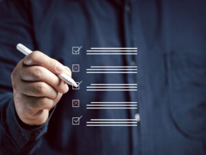 A close-up of a hand marking off items on a digital checklist. This image represents organization and progress tracking, essential components of any digital marketing services list.