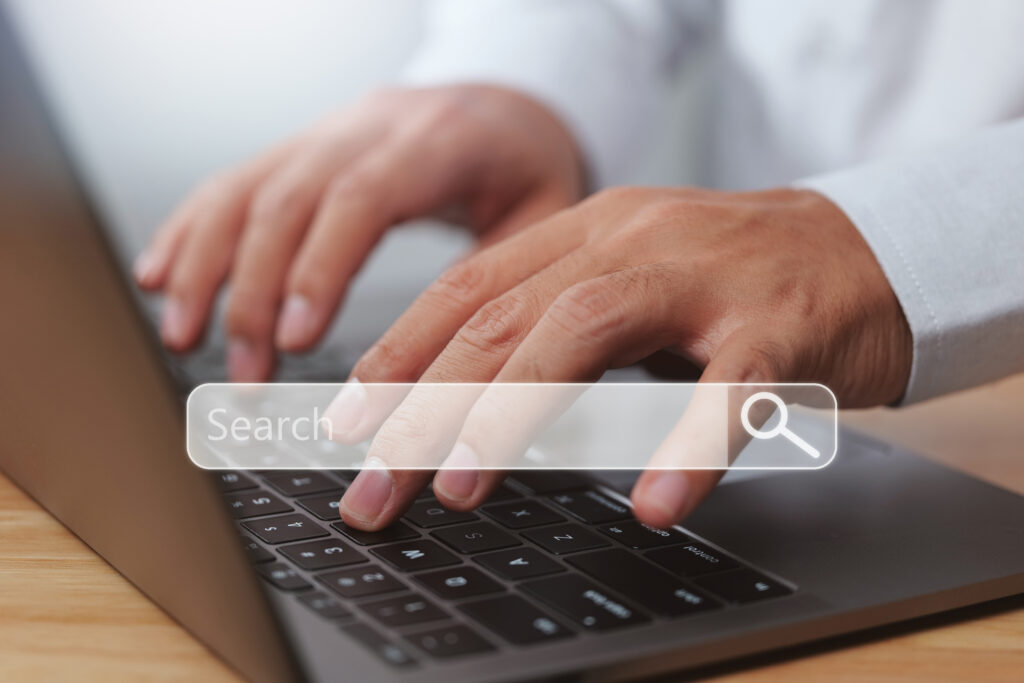 Google ads responsive search ads being used by office professional using a laptop with an overlay of a search bar