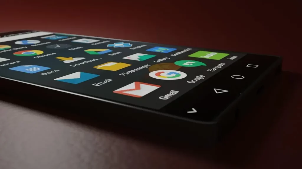 A smartphone displaying various app icons, symbolizing the diverse data sources and user signals utilized in Google Ads Smart Bidding for automated ad optimization.