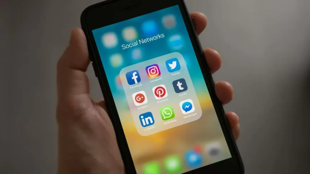 Google Ads targeting options illustrated by a smartphone screen showing various social media app icons, symbolizing audience segmentation across platforms.