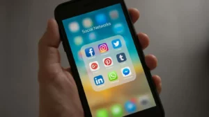 Google Ads targeting options illustrated by a smartphone screen showing various social media app icons, symbolizing audience segmentation across platforms.