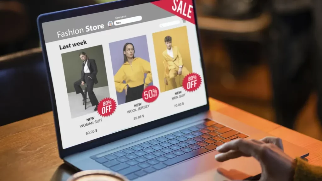A person browsing an online fashion store on a laptop, displaying discounted clothing items with sale tags—illustrating the use of Google Ads for eCommerce promotions.