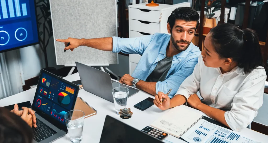 presentation-office-meeting-room-with-analyst-team-prudent Google ads policy compliance being implemented by two business professionals reviewing data