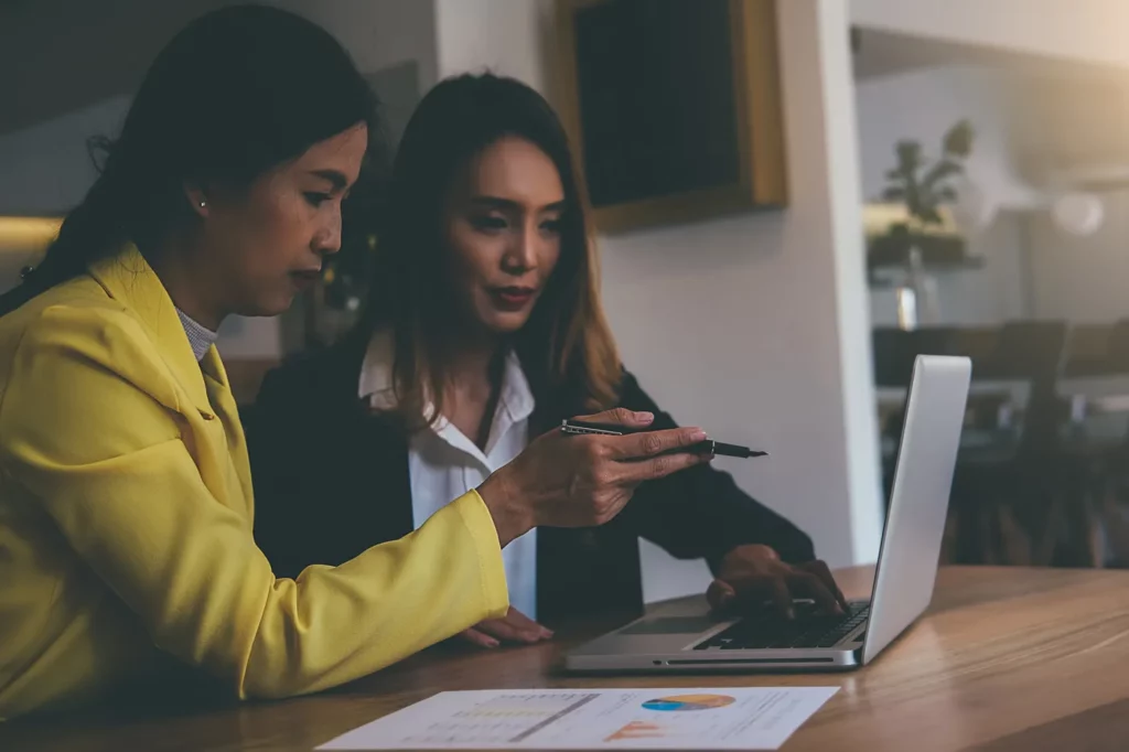 Google ads responsive search ads being discussed by two business women infront of a laptop 
